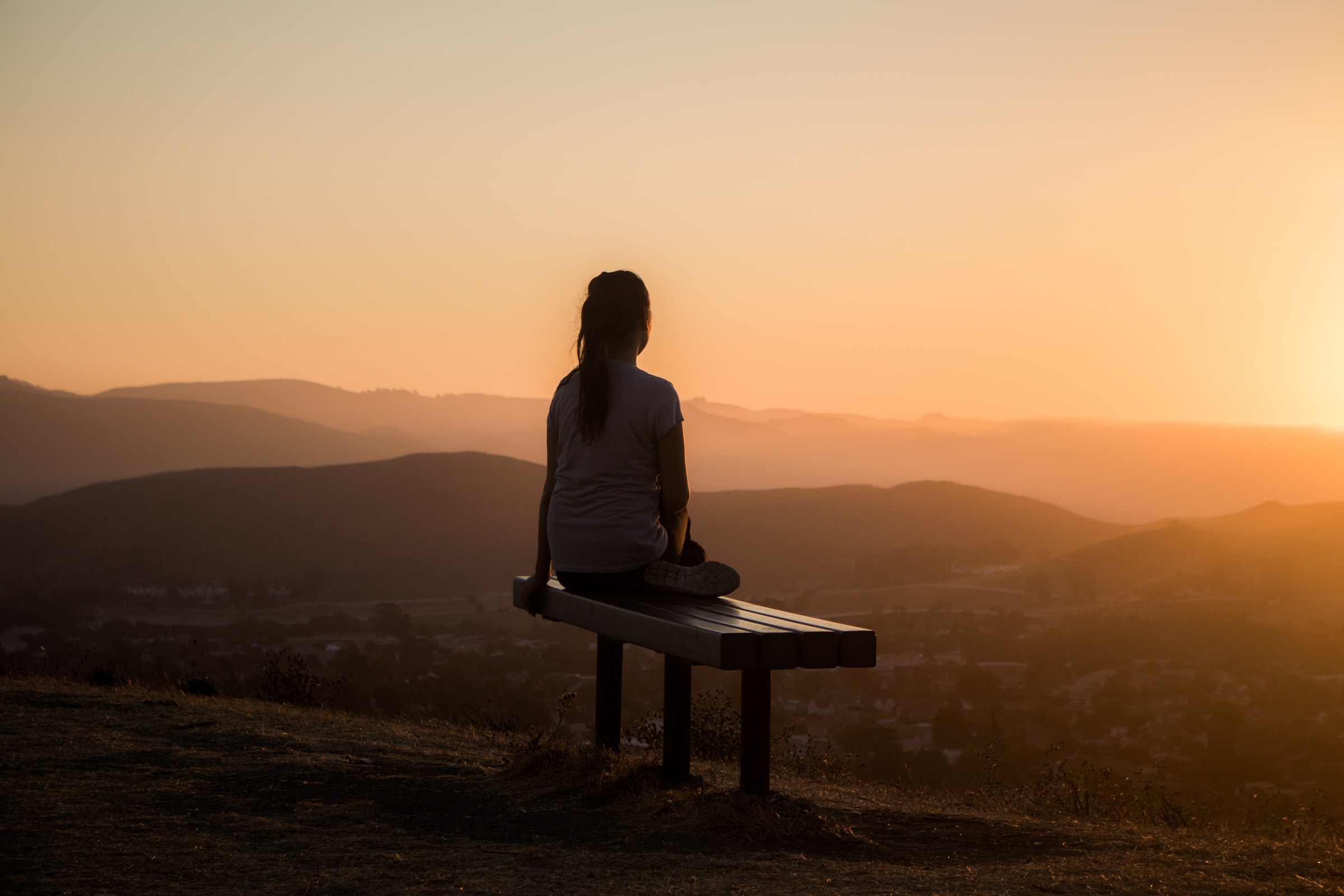 Woman watching sunset, no longer feeling phobic after having using hypnotherapy for phobias